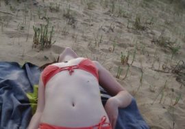 lying on her back in her red bikini