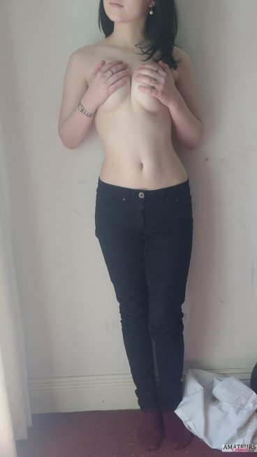 Naked Asian teen squeezing her own tits while still wearing her black jeans